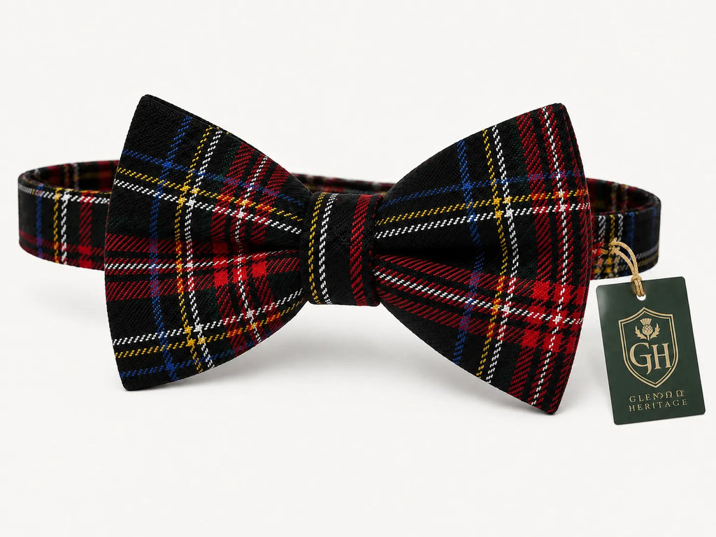 A pre-tied bow tie in a red, black, and blue tartan plaid pattern, shown with a green 'Glenorch Herbace' brand hangtag on a light gray background.