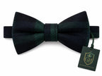 A pre-tied bow tie in a dark green and black plaid pattern, shown with a branded hangtag on a clean white background.